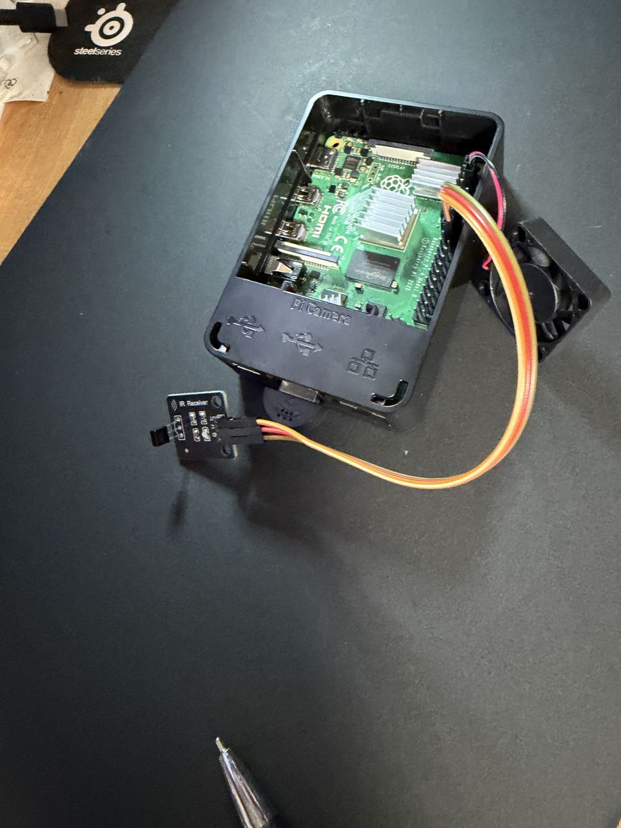 Raspberry Pi in an open case with the IR receiver board wired